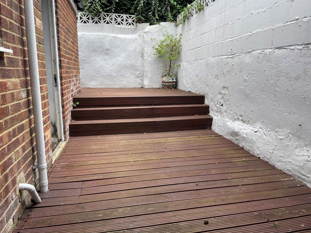 Lot: 142 - GROUND FLOOR FLAT WITH PATIO CLOSE CITY CENTRE - View of decked rear patio from living room